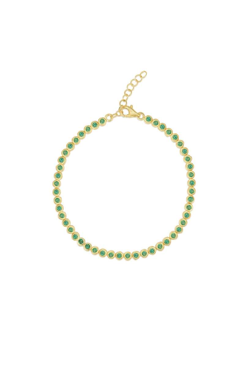 Gold bracelet with green gemstones on a white background